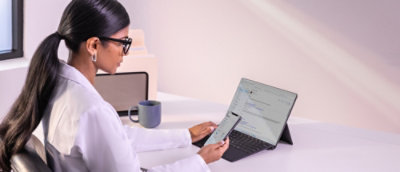 A woman sitting at a desk using a laptop.