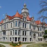 Three-story courthouse with corner gables.