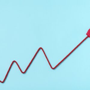 Red Electric Power Plug Adn cable forming a chart on blue background. Increase to electricity prices concept.