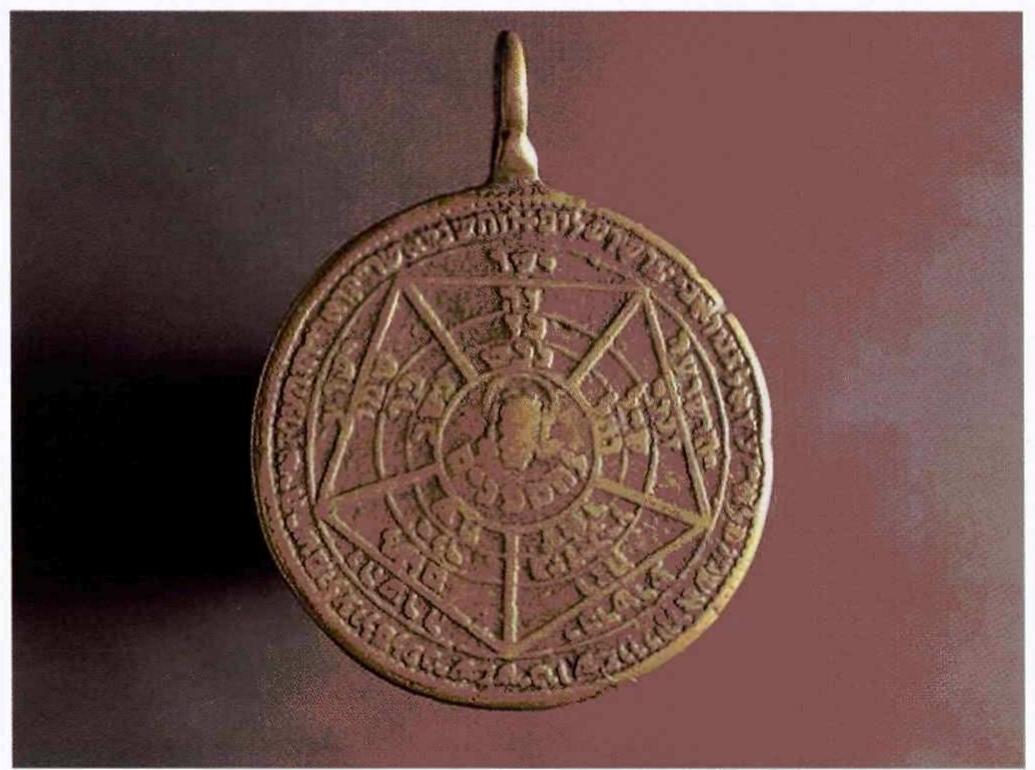 Fig. 11. Holy Medal, Italy, 16th cent., Musée Cluny, Paris  As atule, the divine names inscribed on an object were believed to impart it with mystical powers. The Christian tradition attributed extraordinary powers to Christ’s name and its abbreviations: INRI, an anagram of Iesus Nazarenus Rex Judaeorum, Christ’s Latin title in the titulus crucis;?> and IHS, a Latin version of the Greek abbreviations [HZ or YHX of Jesus. St Bernard of Siena (d. 1444) persuaded the participants in the ceremony of baptism to present a gift of pendants bearing the letters IHS to the newly baptized person.” Christians  the letters IHS to the newly baptized person.”4 Christians 