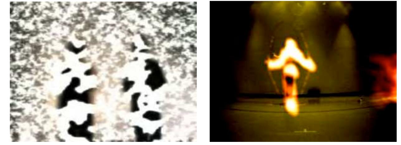 In any case, we now have at hand a variety of pseudo-physical textures with which to construct experimental ’matter” for phenomenological experiments.  Figure 4: A. Silhouettes of two people under Ising model texture. B. Visitor jumping rope transforms herself into ’ fire’ based on movement.  The simplest way to model this is to use the relaxation method as for the Laplace heat equation, but where the values are taken in S! rather than R!. Further experiment is needed to determine whether these simulations of magnetic spin domains driving  re-synthesis of the input video, can constitute substrates for intuitive manipulation of time-varying textures. 