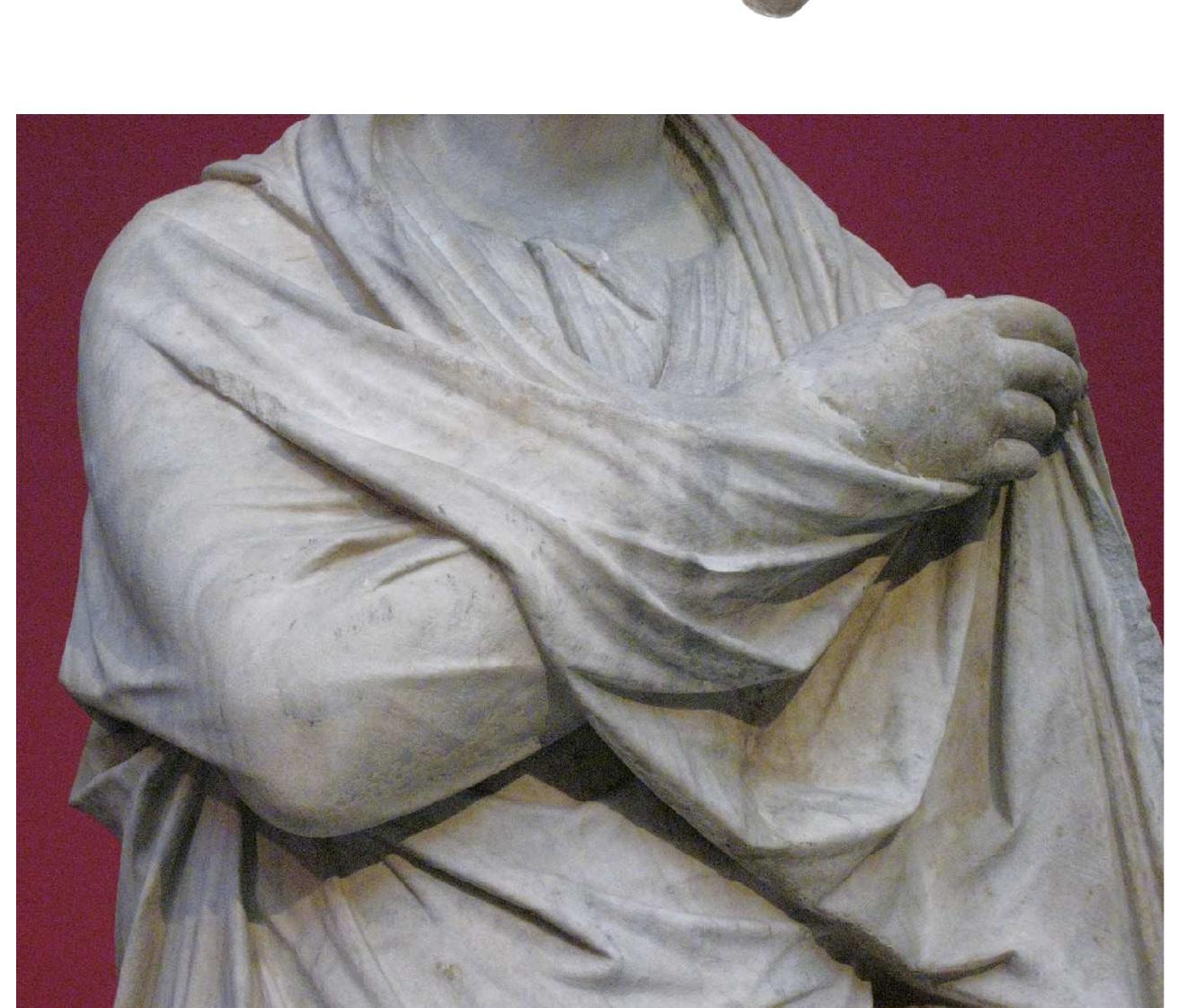 made, in the late 4th century.® The figure’s left arm was apparently slotted into the vertical funnel-shaped cavity behind the drapery cascade. If so, the left elbow must have covered the right hand and wrist, and the left hand either held the hem of the figure’s drapery at neck level or cupped her 