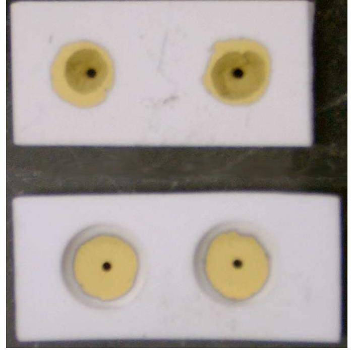 Figure 1 shows two Alumina Tape Ceramic substrates. All of the holes and outer shape were cut freehand using a set of biopsy punches and a razor blade. The bottom substrate was assembled from two substrate pieces which were laminated together using the previously discussed procedures. The substrates were sent to Honeywell for sintering. The gold contacts were then applied by physical vapor deposition (PVD) with the shapes defined by a simple kapton tape mask. While this technology has proved viable for making the detector substrates, development of the Alumina Tape Ceramic substrates was suspended due to the concern of mass production of identical substrates through the S.M.A.R.T. Laboratory.  Figure 1: Prototype detector made from Alumina Tape Ceramics. 