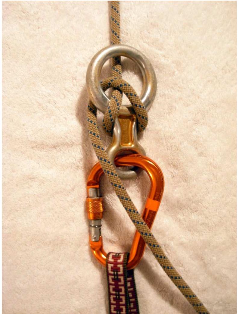 Figure 1.18: Locking Rappel Device  Astronauts on EVA who must venture to these areas of Freyr attach a rope to their harness while on an exterior platform. The ropes are permanently connected to eyebolts by locked-off bowlines. Then the astronaut begins to descend along the shell, clipping their rope to periodic carabiners spaced at 5 meter intervals. This keeps the rope hugging the shell and continuously provides immediate safety for the astronaut. When the shell starts to curve back under, producing a past- vertical surface, the astronaut is held to the hull by adhesive patches modeled on gecko footpads. These patches are self-cleaning and can support the astronaut’s full weight as well as a few tools. By stepping along the hull in this way, astronauts are able to carry out repairs on any part of Freyr. Note, additionally, that astronauts can climb sideways, perpendicular to the centripetal acceleration, because they are supported equally by the carabiners. While on the outside of Freyr in this way, astronauts utilize a locking rappel mechanism that requires only one hand to operate if necessary, and the gecko adhesive pads are placed on the astronaut’s boots, knees, and forearms so that at least one hand can be free. The rappel device is set up so that on all but the very underside of Freyr, both hands can be free while the rappelling rope and the astronaut’s boots and knees support them. Once the astronaut reaches their destination, they can stand upside down on the hull due to the gecko adhesive on their boots and work upside down if necessary, although for some jobs it may be easier to clip into a nearby carabiner and hang from the rope to complete the job. 
