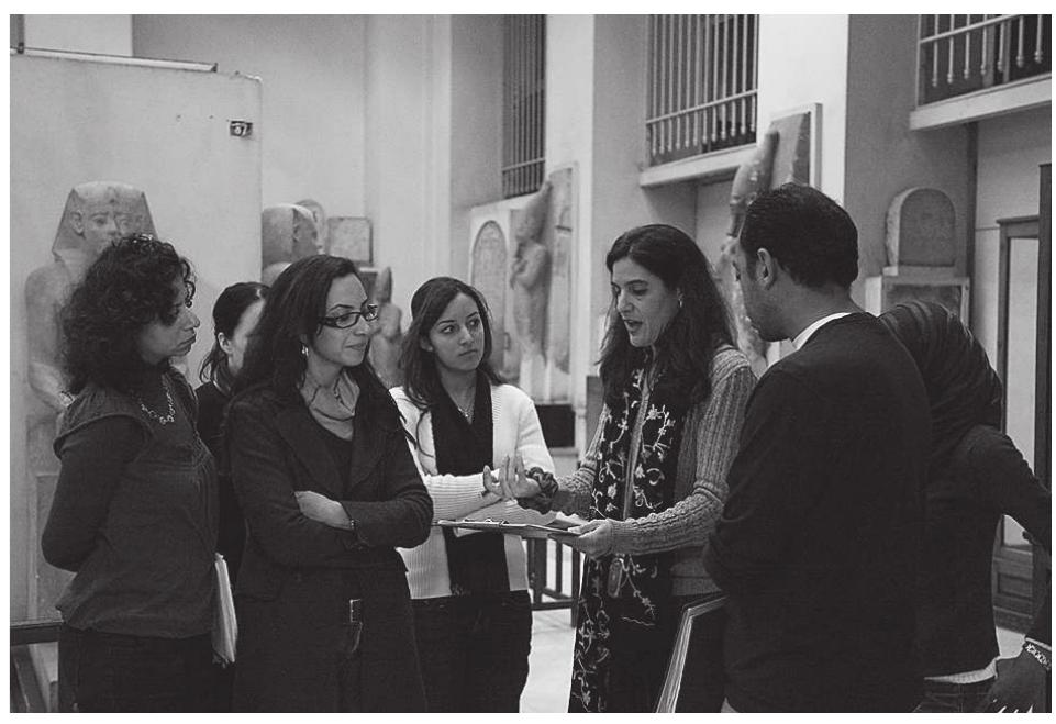 Fig. 10. The author runs a training session in the museum. Left to right: Hanane Gaber, Yasmin El Shazly, Amina El Baroudi, Janice Kamrin, Mohamed Osman  Fig. 11. The author chats with Gerry Scott at a party hosted by ARCE for the museum staff in April 2009. To the left are Principal Project Consultant, Rachel Mauldin, and EAC Director, Michael Jones  Fig. 9. Marwa Abdel Razik and Angy Abdelaziz join a movement committee 