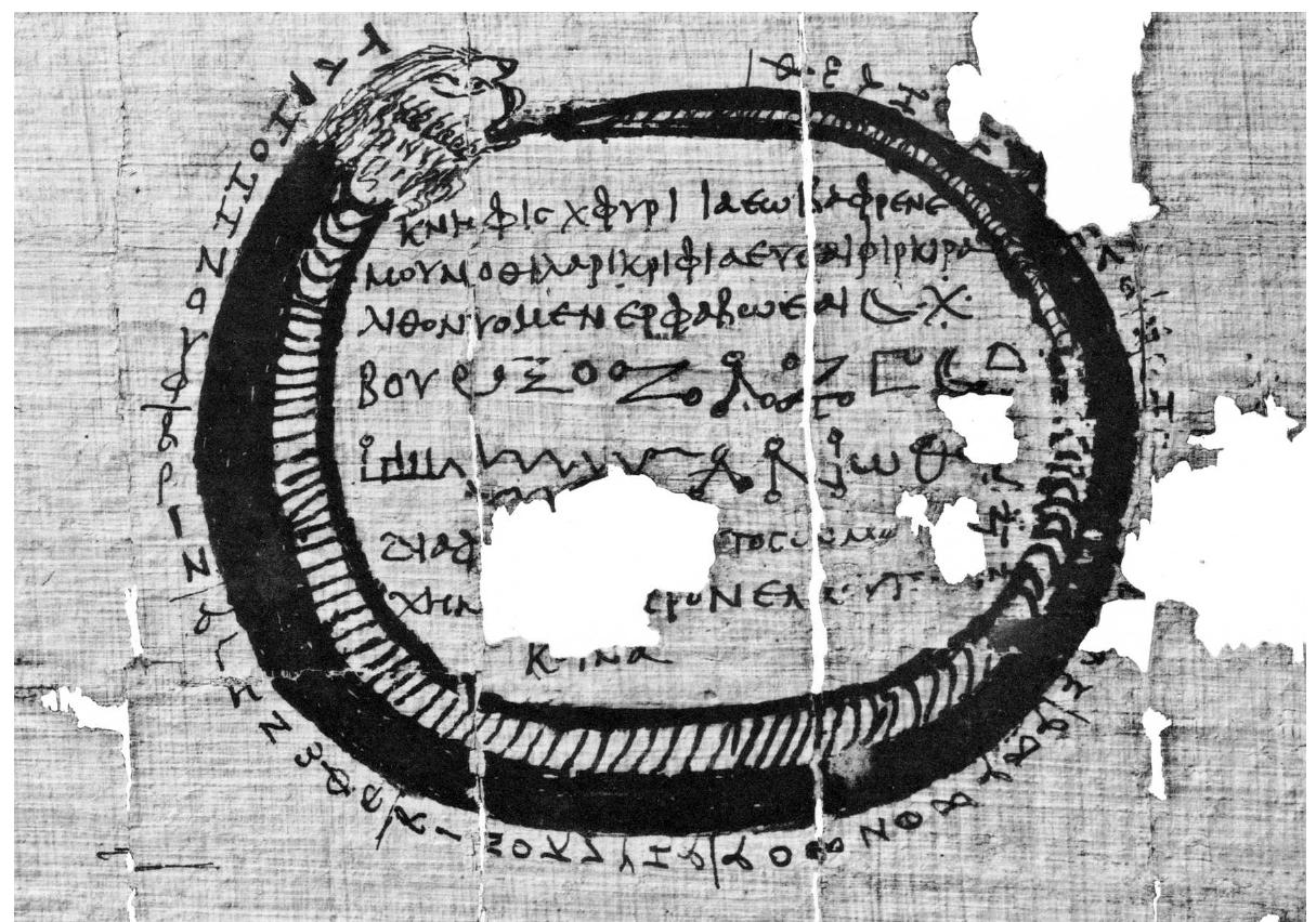 FIG. 21.5 Protective design to be inscribed on amulet. The design shows the ouroboros snake (which eats its own tail) encircling an incantation consisting of a series of voces magicae, kharakteres, and the request ‘Protect my body and the entire life of me, NN’ as prescribed in the accompanying recipe PGM VII 579-90. From Thebes, third century CE 