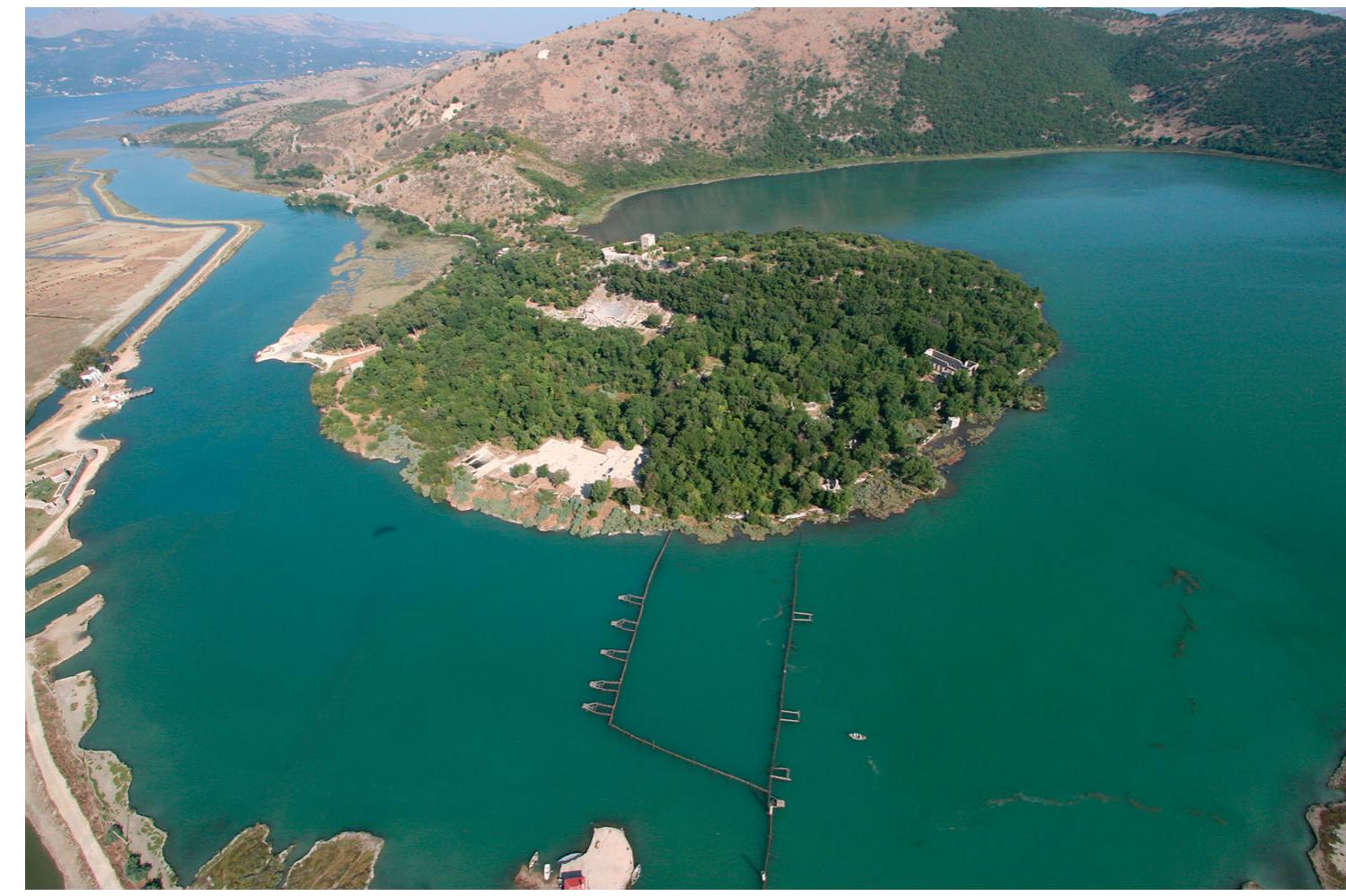 Figure 2. Butrint. Photograph courtesy of the Butrint Foundation.  The stratification of the lower city is deep and complex, the product of geologic subsidence of the Butrint headland and of more than two millennia of settlement (FIGURE 6). The site of the forum is a densely built environment, where numerous construction, reconstruction, and demolition enterprises have occurred since antiquity. With no modern  urban development on the headland, Butrint preserves traces of its past better, in many ways, than sites with continuous occupation into modern times. The archaeological record of the RFE Project consists of almost 3000 distinct contexts (deposits, masonry structures, interfaces), which date from the 7th century B.c. to the 16th century A.D. The complexity of stratification and variable conditions of subsurface preser- vation, combined with the density of contexts, encouraged the RFE Project to develop new approaches to fieldwork. 