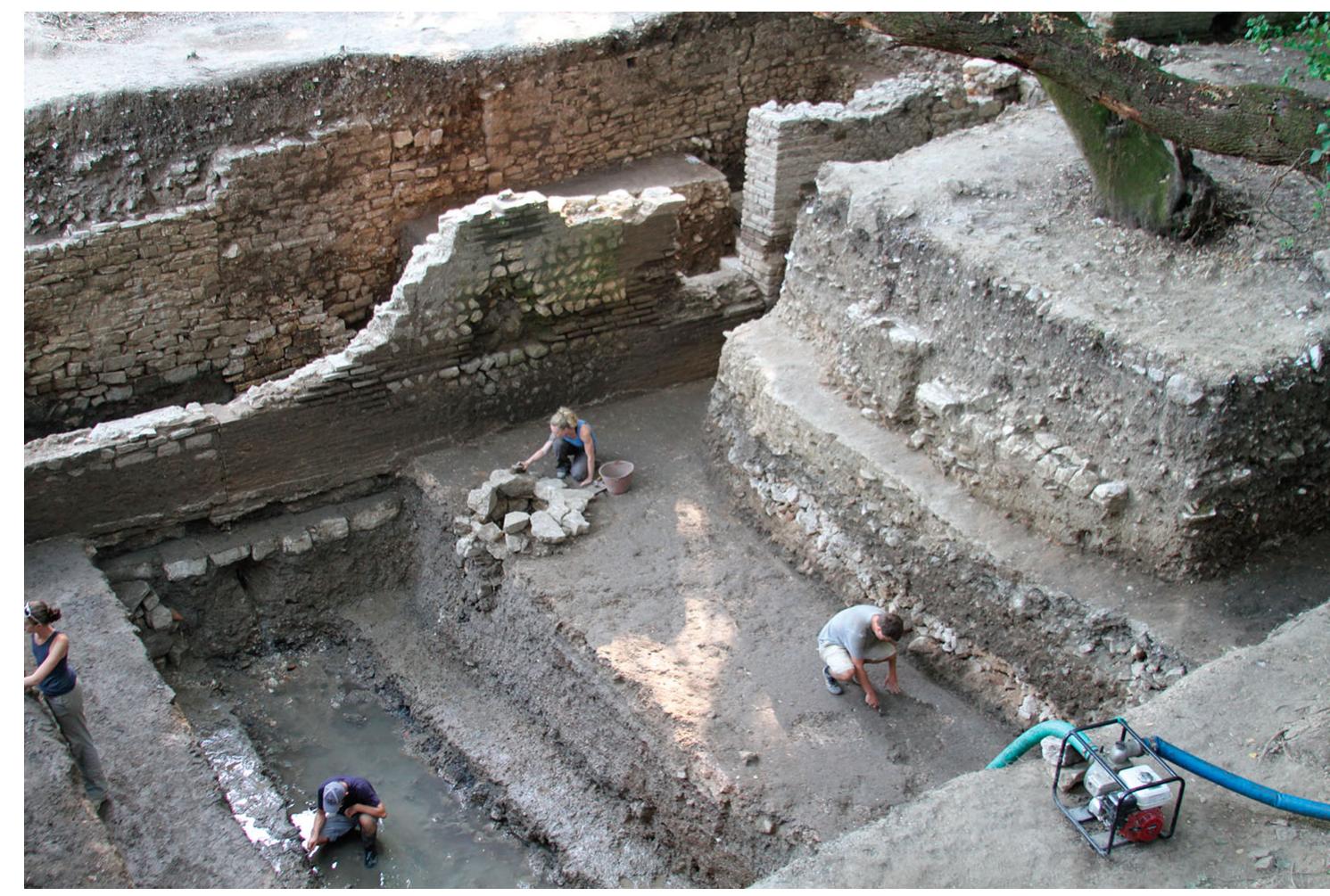 Figure 4. Excavation inside the Roman Basilica in 2012 (Unit 21).  Archaeological methodology encompasses a broad spec- trum of issues: excavation techniques, documentation pro- cedures, personnel, data analyses, conceptual frameworks of interpretation, institutional power structures, academia, fund- ing sources, stakeholders, the philosophical paradigms of exca- vators, the legacies of colonialism and nationalism, political interests, and more. In view of this reality, new theoretical approaches to the discipline have emerged, focused largely on the role of the archaeologist in the production of the  archaeological record (Binford 1962; Hodder 1999, 2012; Lucas 2001, 2012; Johnson 2010; Preucel and Mrozowski 2010). We can trace how ambition, archaeological training, nationalist ideologies, colonialism, politics, funding, and also the natural environment influenced Ugolini’s excavations and findings at Butrint (Gilkes 2004). Similarly, Enver Hoxha’s communist government drove archaeologists in Albania to search for an Illyrian ancestry to bolster nationalist claims of sovereignty and autochthony in Epirus. More recently, wealthy 