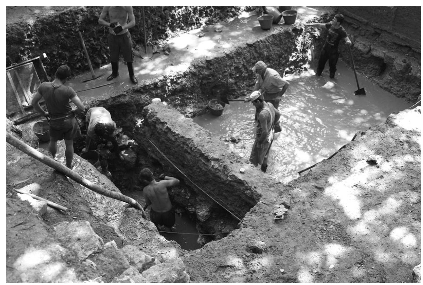 Fig. 21. Excavation at the Basilica, Unit 21 (drainage trench on the left); RFE Project Excavations, 2012.  as required in the lower city of Butrint, also presents hazards. To ensure trench stability and avoid collapse, it is imperative to design the wet trench to be much smaller than the main trench and to place it some distance away from the walls of the main trench, so that the wet trench effectively serves as a separate trench altogether and does not form part of a continuously stepped trench from the surface. Thus, the size of the initial (main) trench must be very large in the lower city of Butrint to permit wet-site excavation.  as required in the lower city of Butrint, also presents hazards. To ensure trench stability and avoid 