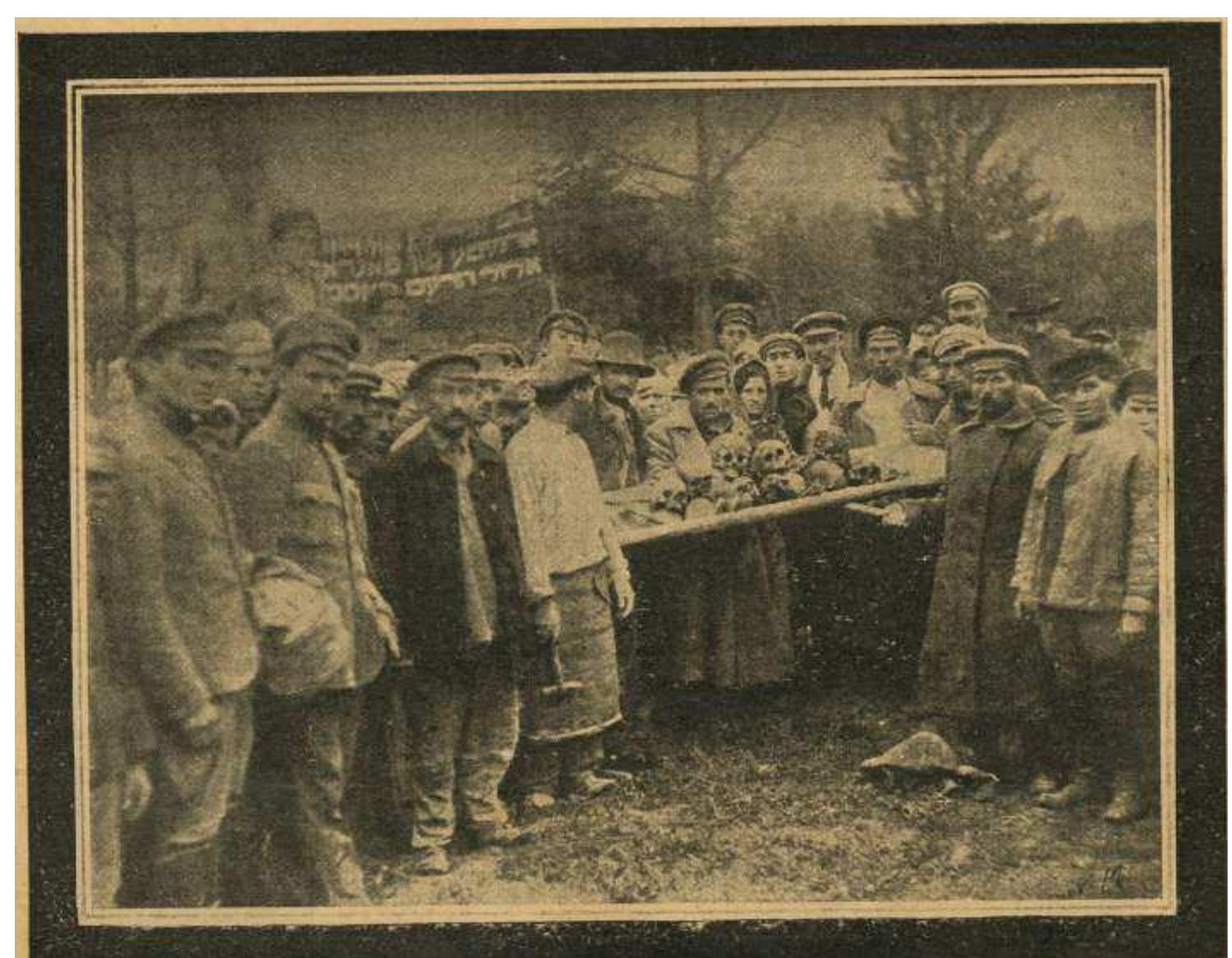 Fig. 1: Local Jews display a makeshift stretcher with the skulls of victims of the Fastov pogrom at the memorial procession to commemorate the pogrom. The banner in Yiddish reads: “In memory of those  killed during the pogrom, September rorg, in Fastov.” In Z. S. Ostrovskii, Evreiskie pogromy, 1918-1921, (Moscow: Shkola i kniga 1926), 30. Courtesy of the Blavatnik Archive, New York. 