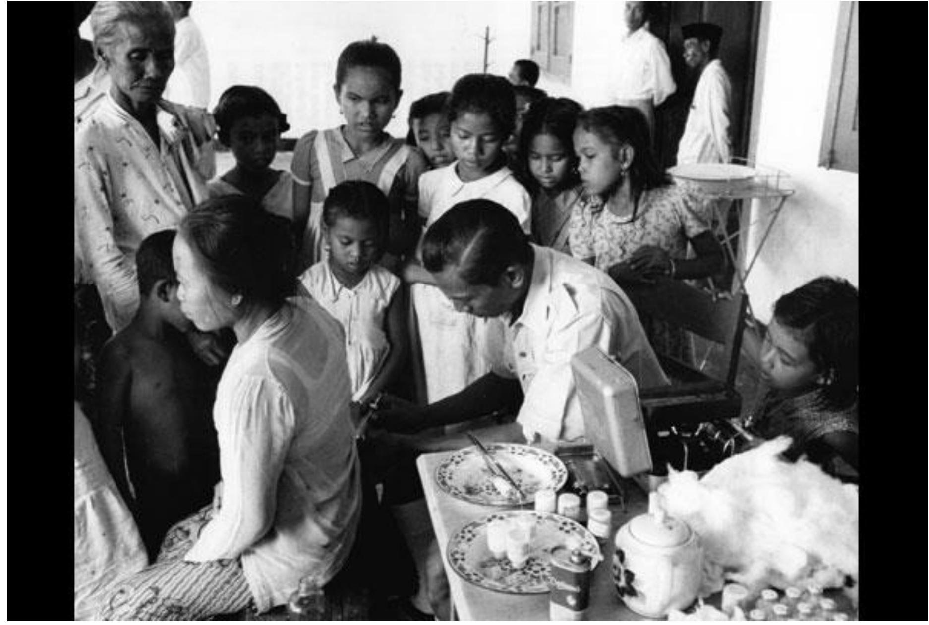 The 299 villagers of Njamplang are examined. Forty-seven persons, of whom nine are infectious, are given an injection of repository penicillin. Often, a preventive injection is given to the entire village population. Below: Mass Treatment of Yaws Patients