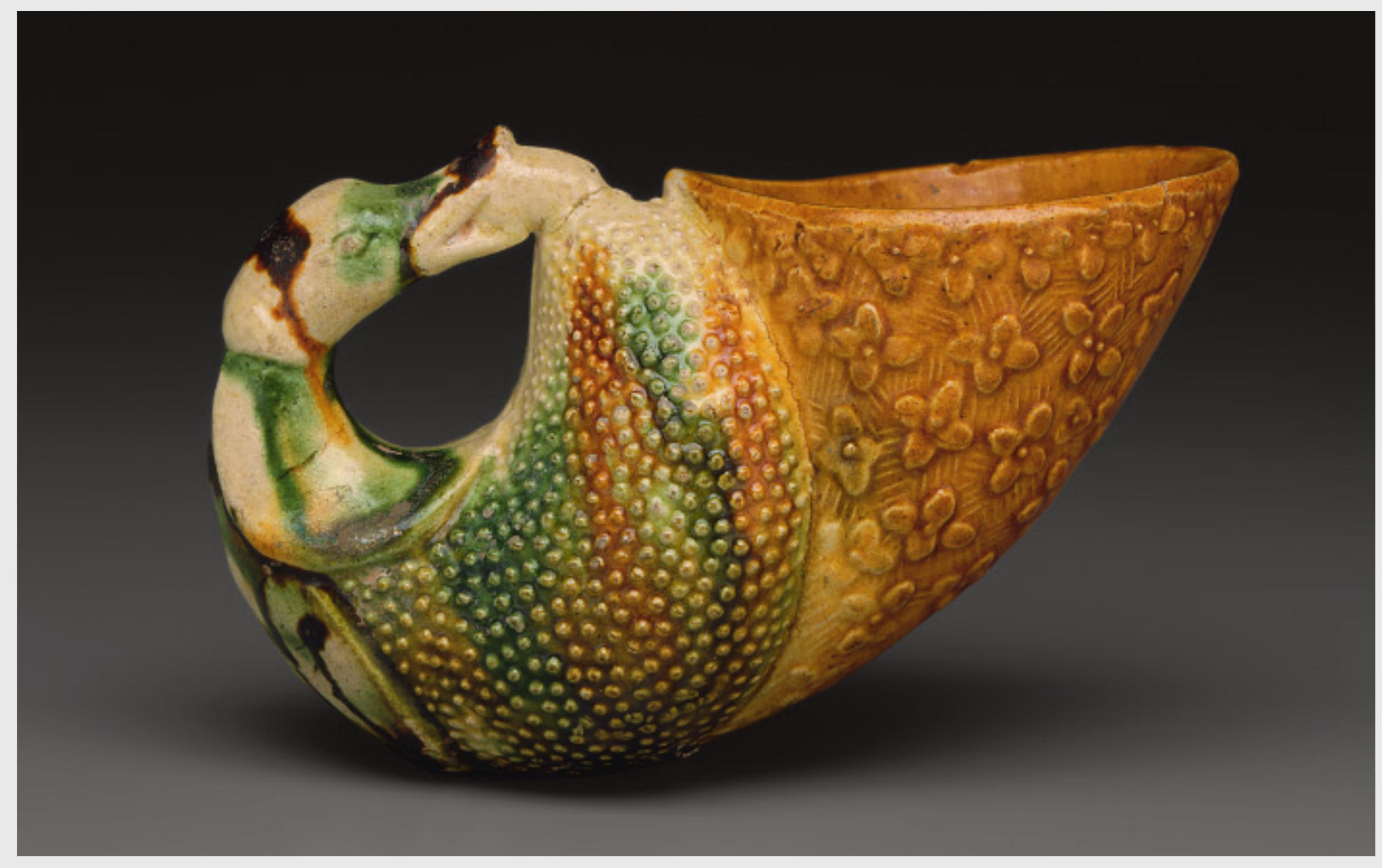 In China, the rhyton’s image as an exotic treasure became compounded over the course of the seventh century, as ceramic kilns began to produce rhyton-like funerary objects intended to be placed in tombs. At the time, burial ceramics were marketed as representations of more precious possessions used in daily life, such as silver- ware, exotica, horses, or slaves. But they were not meant to be exact translations of their prototypes. Instead, their design emphasized a language of distortion and exag- geration, which was considered appropriate for the world of the dead. Rhyta were referenced simply as cups with animal features, without an outlet in the animal’s mouth. An early example of this genre is a cup now in the British Museum, London. Here, the potter combined the con- cept ofa lion forepart with elements of Western gold- and silverwork, such as gold granulated roundels, repoussé relief decoration, and an octagonal body (see Fig. 7.35).  Kuhn, Chinas goldenes Zeitalter; Qi and Shen, Hua wu da Tang chun; Hansen, “Hejia Village Hoard”; Qi, “The Hejiacun Treasure and Sogdian Culture”; Lerner, Aspects of Assimilation; Louis, “The Hejiacun Rhyton and the Chinese Wine Horn (Gong)”; and Rawson, “Inside Out.” 