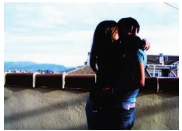Figure 8: Kissing couple picture. Sharp contrast hides boyfriend's face.  cdl  While some girls construct eroticized images with their boyfriends (e.g. portraying herself and her boyfriend together naked on the bed suggesting an after-sex moment), others prefer tenderness by highlighting hugs, soft kisses, caresses ... or just putting their heads together. As we have suggested, kiss- ing scenes are the main theme in our sample, and in some cases girls also 