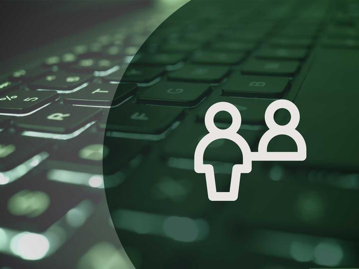 Icon of a customer at a help desk in front of a photo of a computer keyboard.