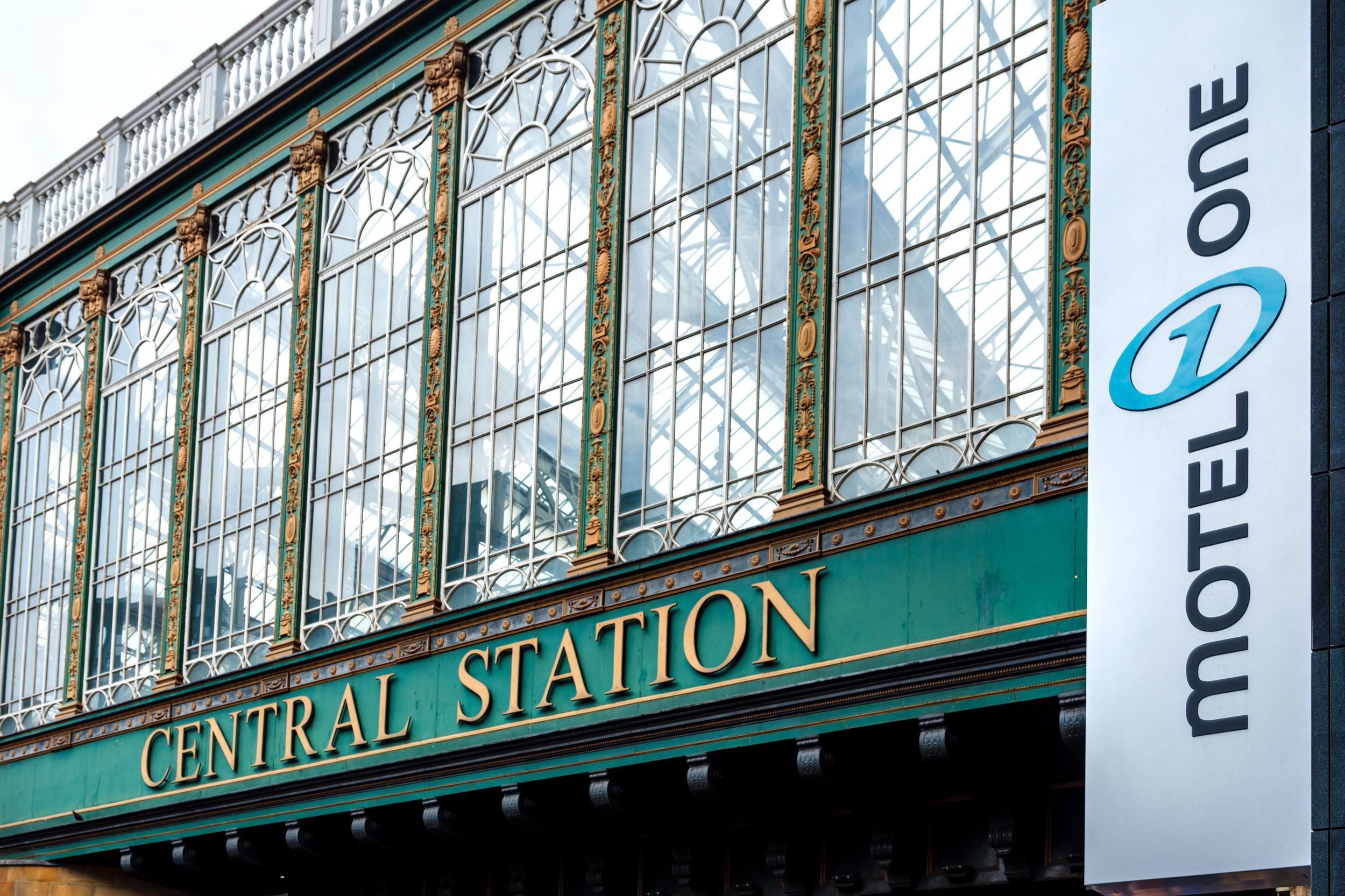 hotel Glasgow Motel One view of the facade of Central Station and the Motel One logo on the side