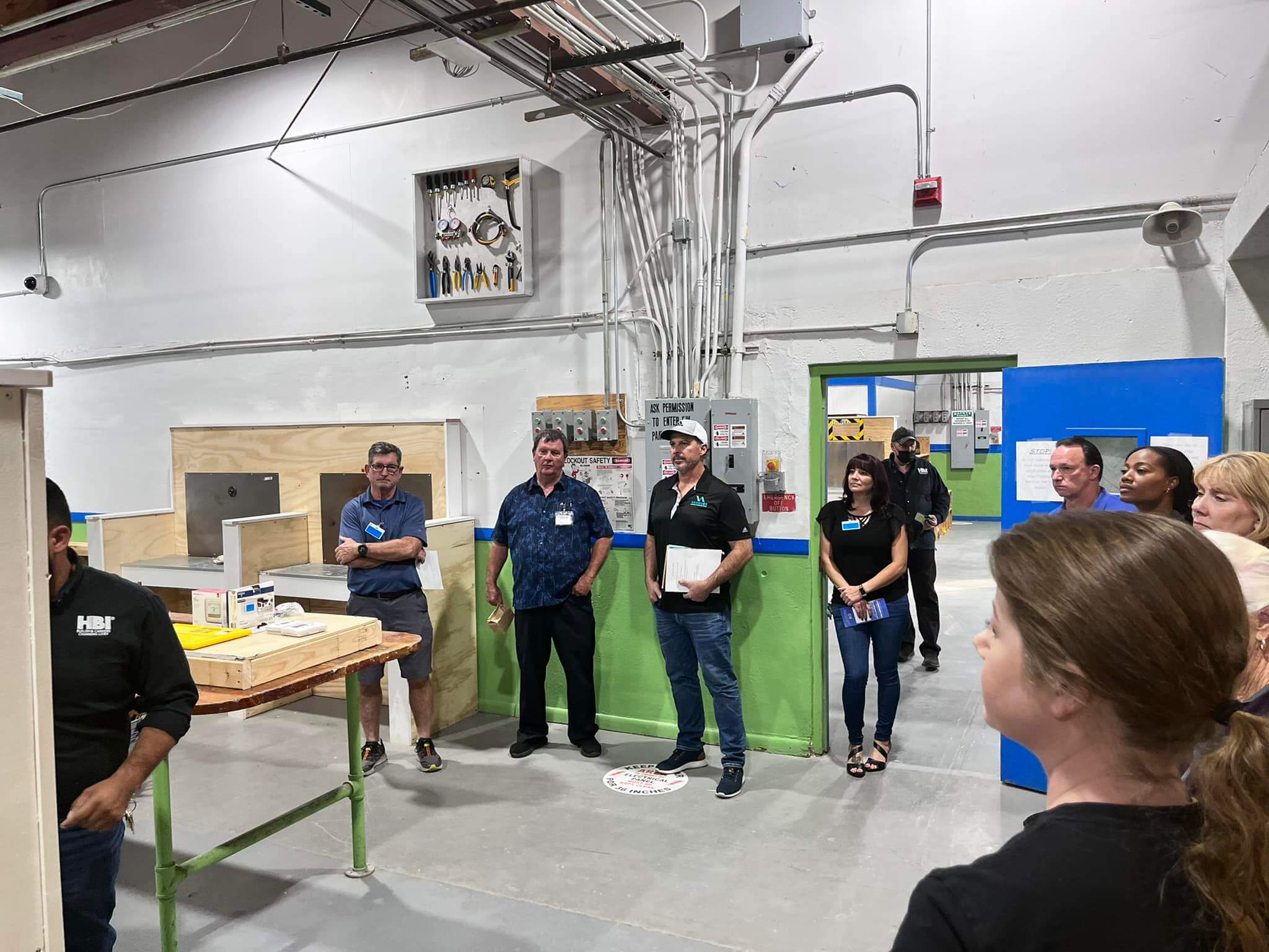 Home builders in a warehouse attending construction training programs