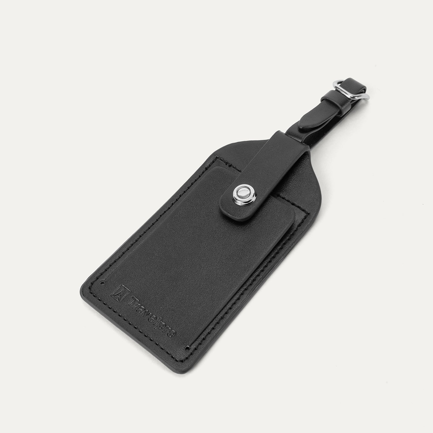 Close-up of the premium black leather luggage tag included with the Travelpro Platinum Elite Carry-On Hardside Spinner, featuring an embossed Travelpro logo and a secure snap-button closure.