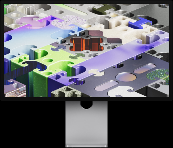 Parte frontal del Studio Display XDR con un fondo de pantalla tridimensional con diseño de rompecabezas