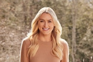 Julia Mcguire wearing a brown sweater in front of a tree backdrop