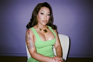 K Michelle posing in front of a backdrop.