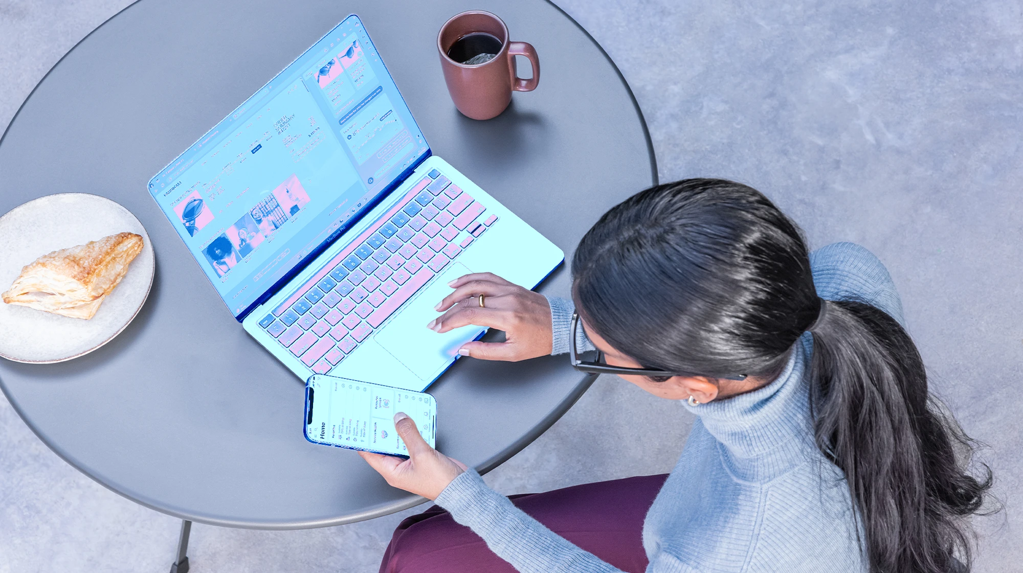 A woman sitting at a table using a laptop