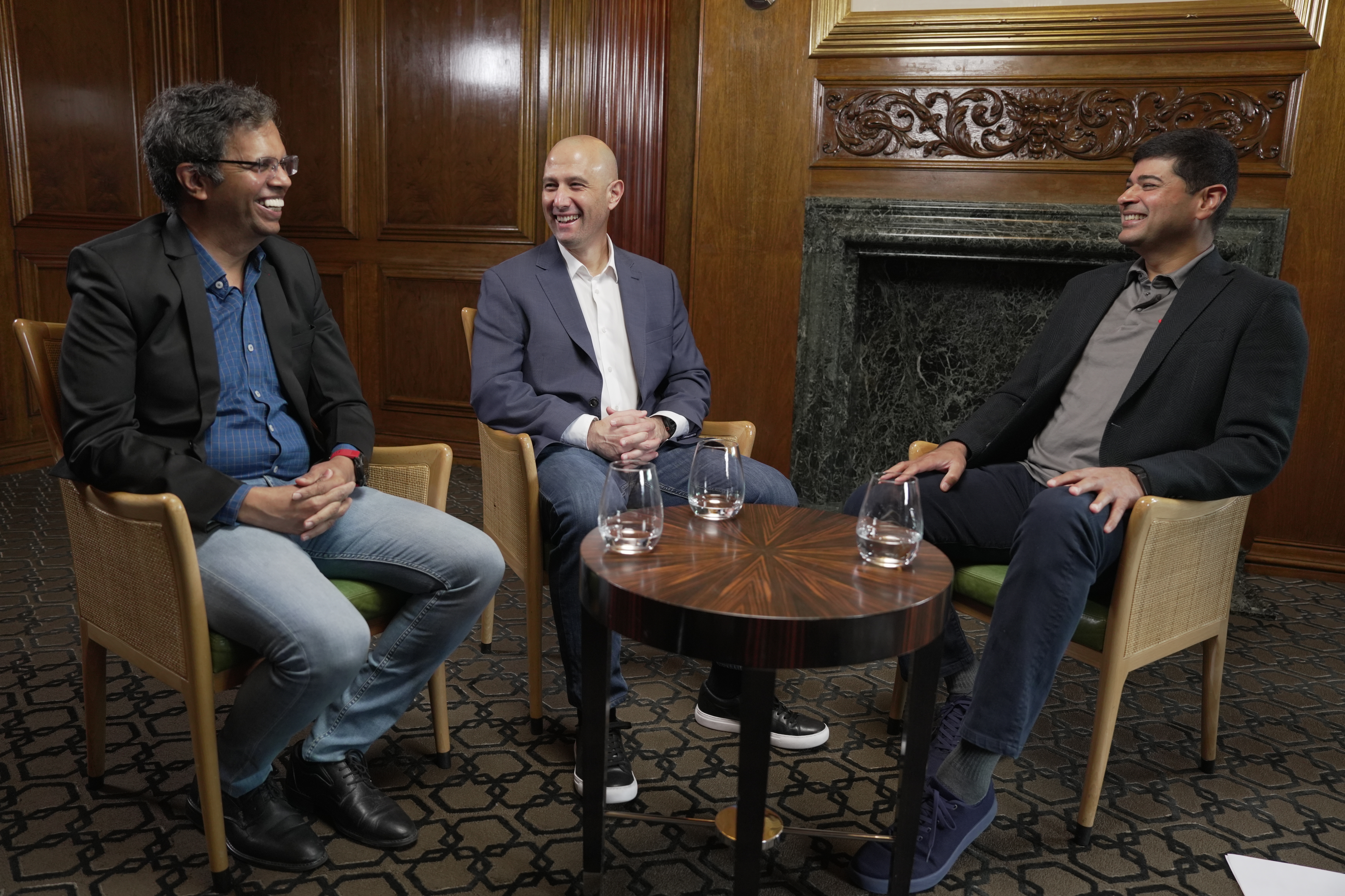 Males talking at table with water